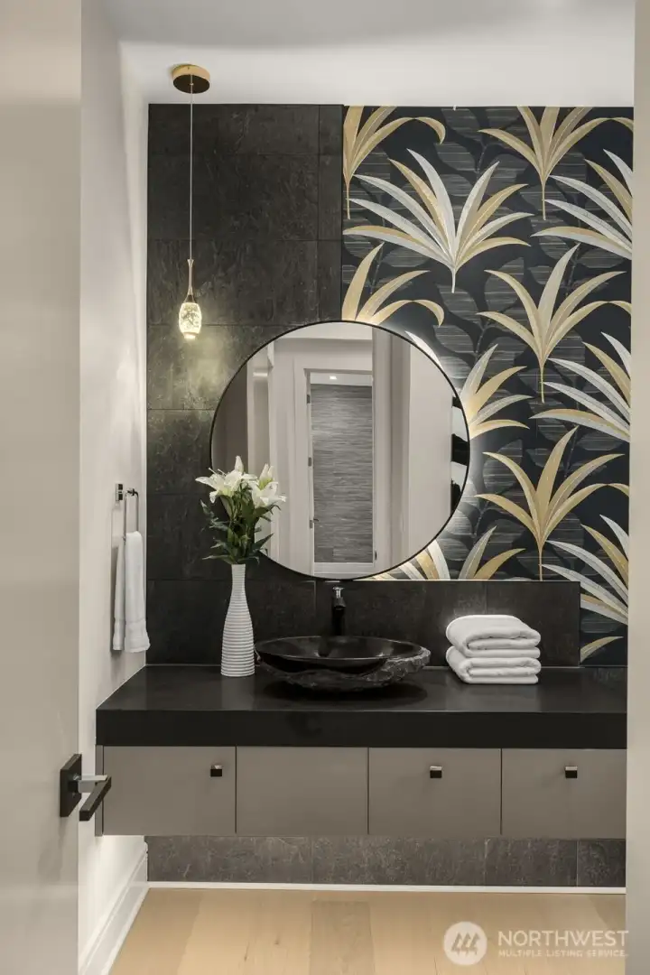 Chic Powder Bath w/ Floating Vanity, Vessel Sink, Wall-Hung Toilet & Boutique Wallpaper.