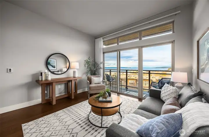 The same bright, open living room, this time highlighting the expansive windows that frame stunning views beyond, filling the space with light and creating a seamless connection between indoors and out.