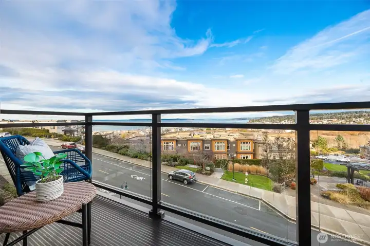 A private balcony overlooking the Port of Edmonds, where sweeping water views, passing ferries and marina activity create a constantly changing, picture-perfect backdrop.