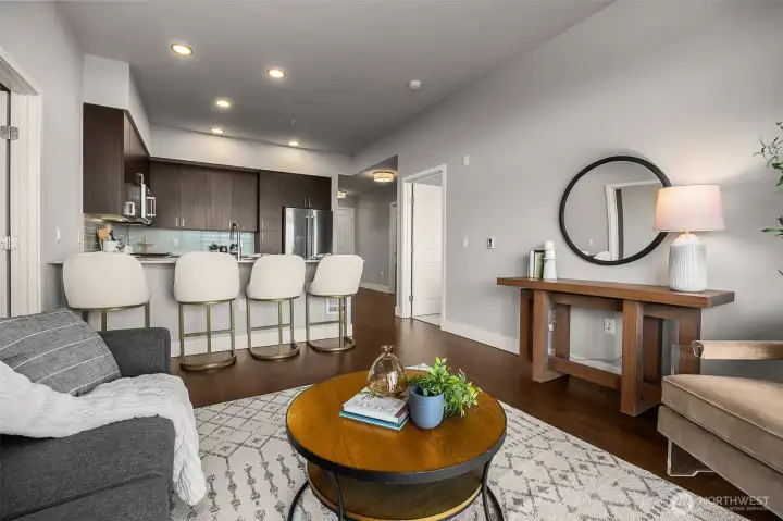 A spacious, open-concept living room with soaring ceilings, perfect for entertaining. The airy layout flows seamlessly into the adjoining spaces, creating a bright and inviting atmosphere.