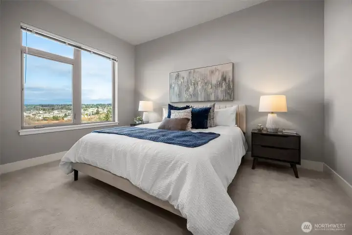 A spacious primary bedroom that easily fits a king-size bed with room to spare, offering stunning views that make waking up here truly special.