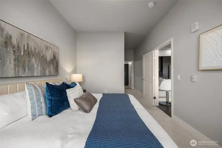 A generously sized primary bedroom with ample space for a king-size bed, seating area, and more, all while showcasing breathtaking views.