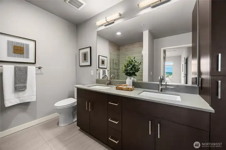 An elegant ensuite bath featuring a spacious double vanity with ample storage and a luxurious, spa-like feel.