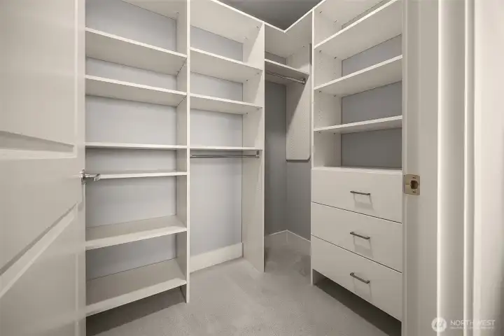 Secondary bedroom with a custom closet, providing generous storage, a bright and airy feel, and plenty of room to personalize.