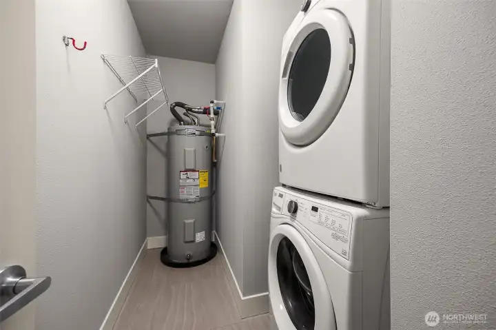 Spacious laundry room with stacked washer and dryer, offering plenty of room for storage.