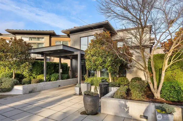The main entrance to 50 Pine, featuring the sleek modern design, welcoming entryway, and well-maintained landscaping that sets the tone for the luxury within.