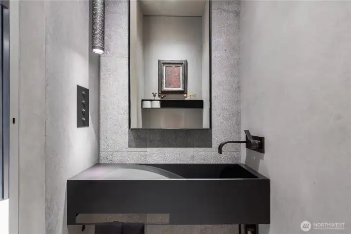 Entry hall powder room with custom steel sink, faucet and details.