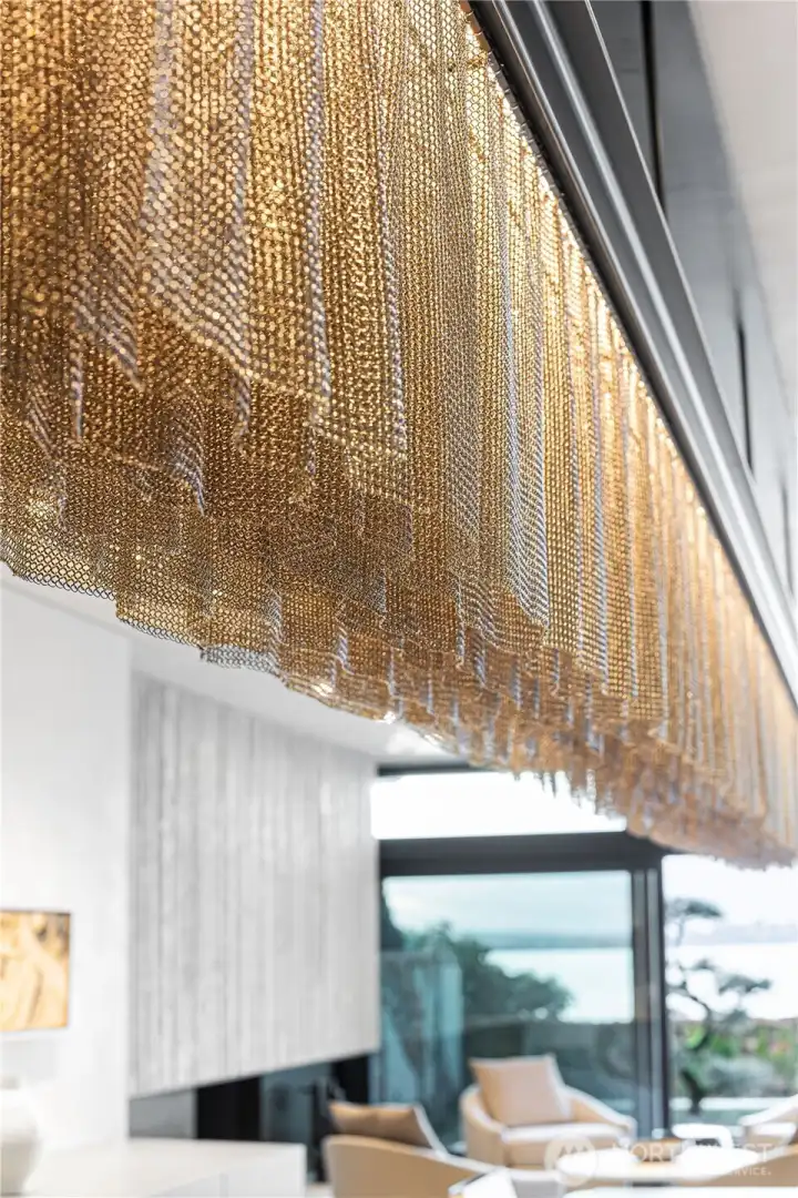 Custom stainless steel chain mail dinning room light fixture.