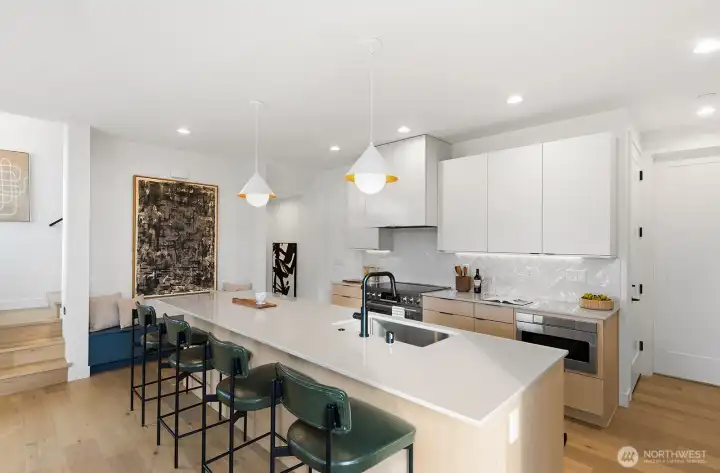 Chef's kitchen with a large island, SS appliances, and plenty of custom cabinetry.