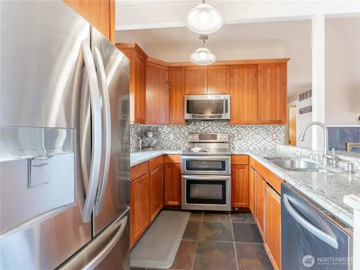 Functional kitchen layout with updated finishes and storage.