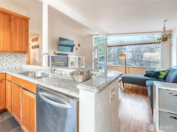 Bright living room with original hardwood floors and wood-burning fireplace.