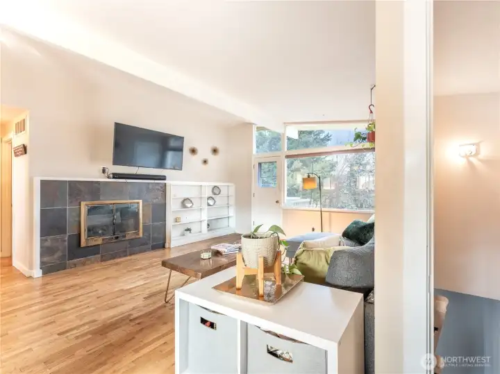 Spacious mid-century living room with large windows and natural light.