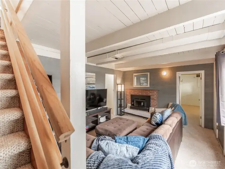 Lower level family room with second wood-burning fireplace