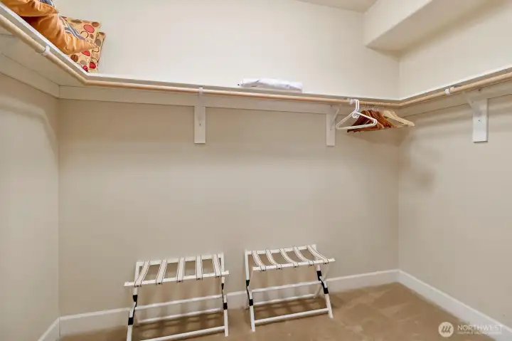Spacious walk-in closet with open hanging space and room for additional organization, offering flexibility to customize storage to your needs.