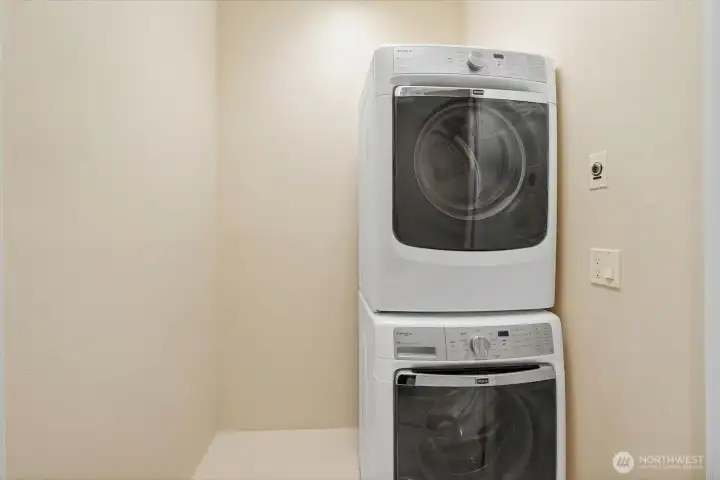 Laundry closet with stackable washer and dryer, allowing for additional storage space for cleaning supplies, vacuum, and everyday essentials.