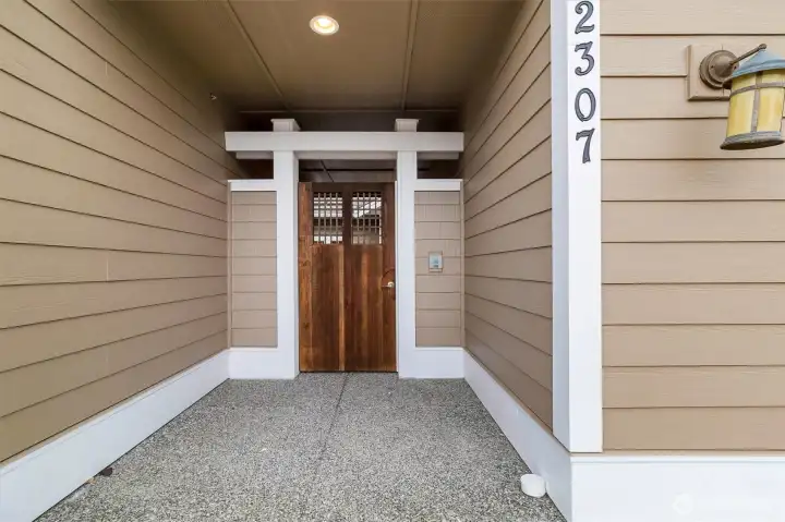 Gated entry from the street leads into a private courtyard, creating a sense of arrival while adding both privacy and security.