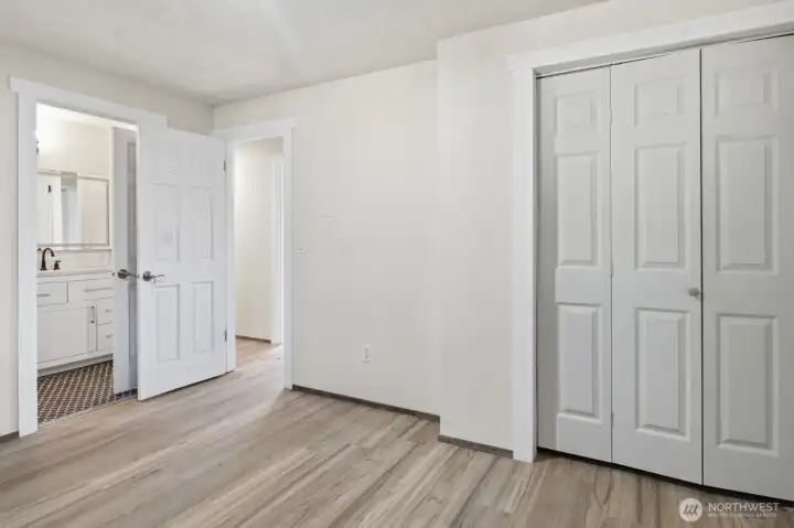 Primary suite has it's own entrance to the shared bathroom and easy maintenance flooring.