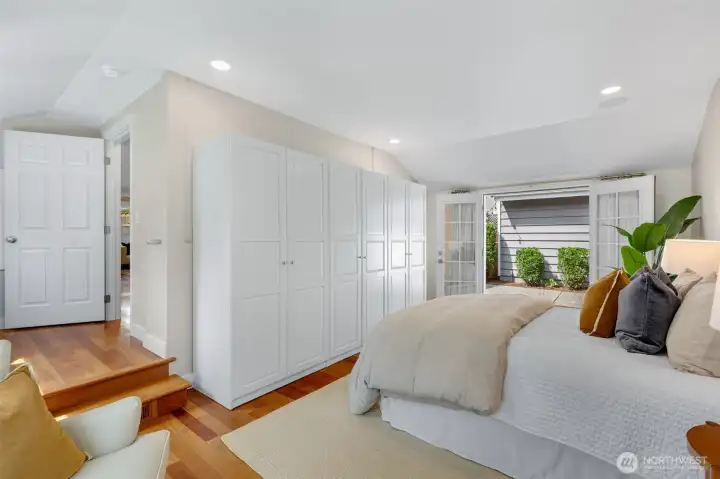 primary suite with french doors to backyard
