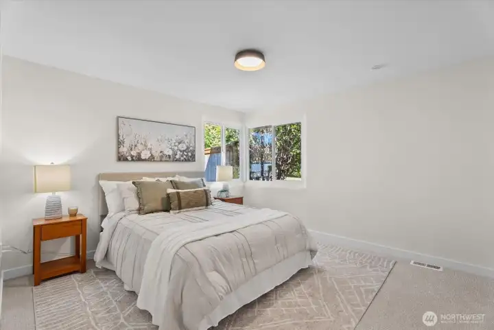 primary bedroom with lots of light and walk in closet
