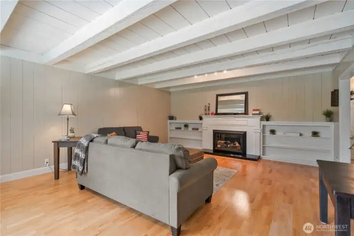 Beautiful living room with gas fireplace, engineered hardwood floors, custom built ins, natural light Beautiful living room with gas fireplace, engineered hardwood floors, custom built ins, natural light