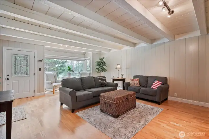 Beautiful living room with gas fireplace, engineered hardwood floors, custom built ins, natural light Beautiful living room with gas fireplace, engineered hardwood floors, custom built ins, natural light