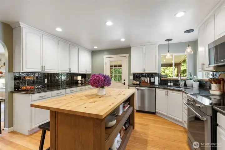 Updated Kitchen with farmhouse feel with butcher block island