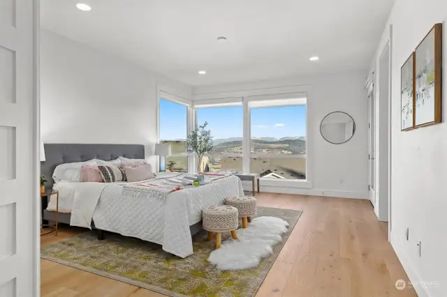 Primary suite bedroom with recessed lighting.