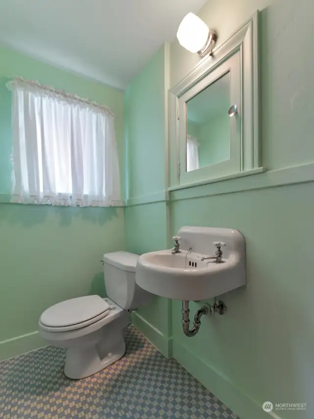 The charming upstairs half bath.