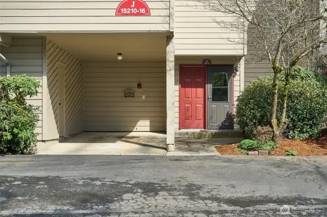 Private, covered carport parking with storage unit is a great addition to this unit.