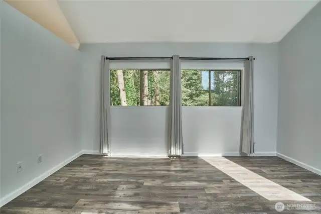 Double windows in primary bedroom provides a beautiful view to the backyard greenbelt.
