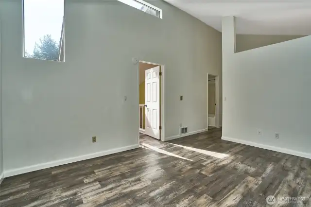 Looking back at entry into the primary bedroom presents again the amount of natural light in this home.