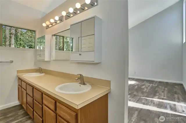 The double vanity with closet enhances  openness and space.