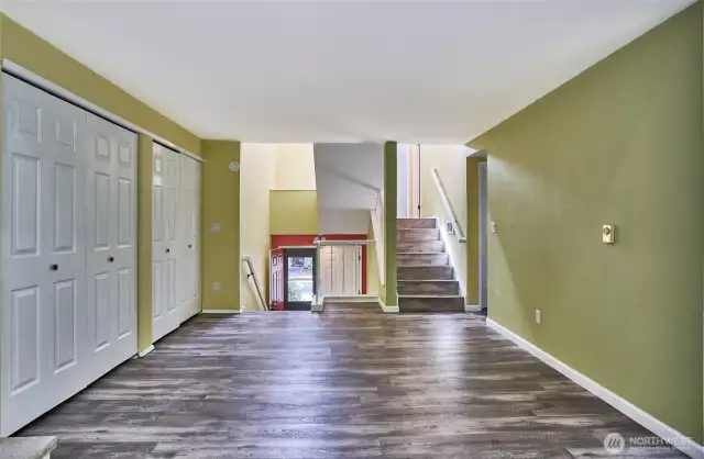This view shows the vaulted ceiling entry and stairs to the upper levels.