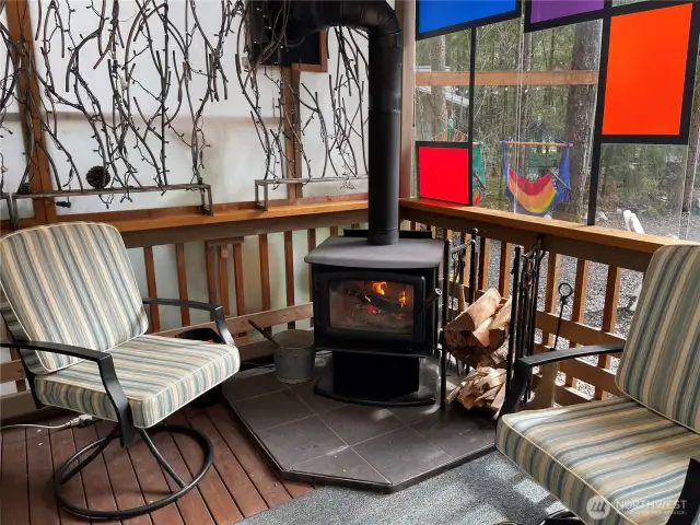 Step up on the partially enclosed deck, and enjoy the warmth of the woodstove.