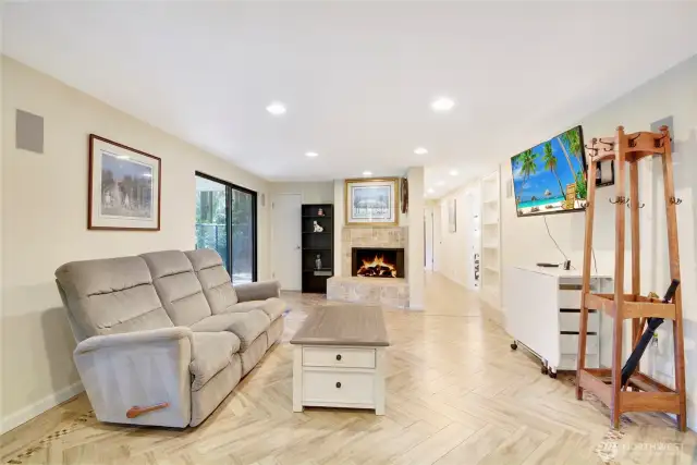 Living Room w/wood-burning fireplace & tile flooring, lower level