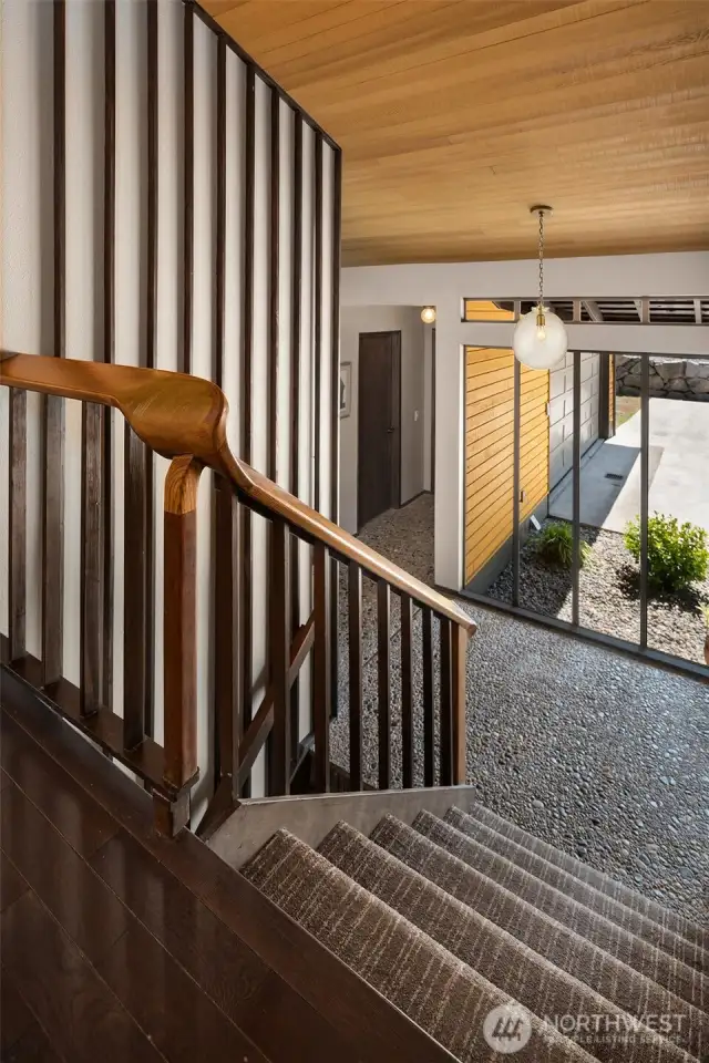 The curving wood handrail is a work of art in itself!