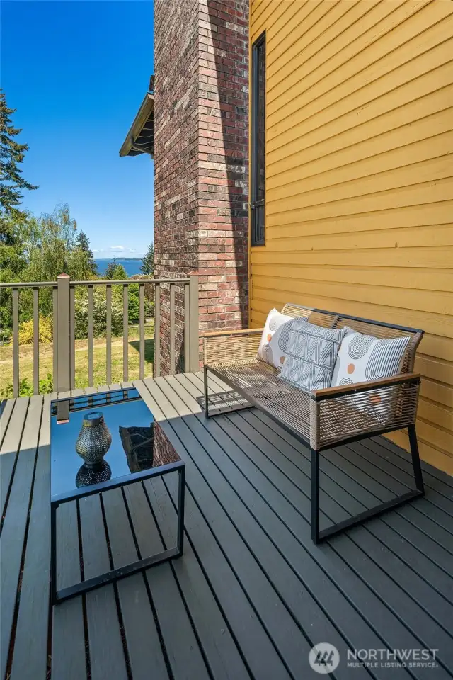 Primary bedroom deck with view of the sound, orchard, and rolling pasture.