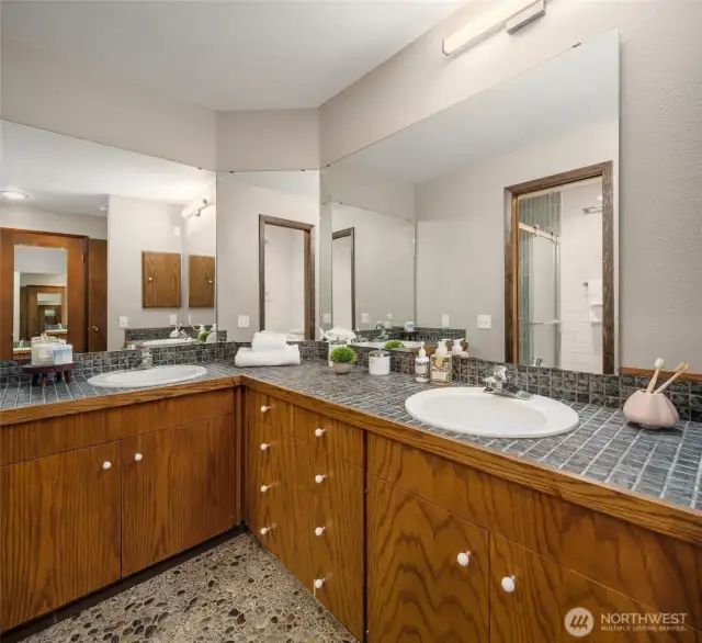 Primary full bathroom with double sinks, new countertops, new commode room and shower.