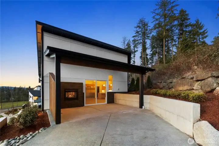 Large extended covered patio off the living and dining room with gas fireplace