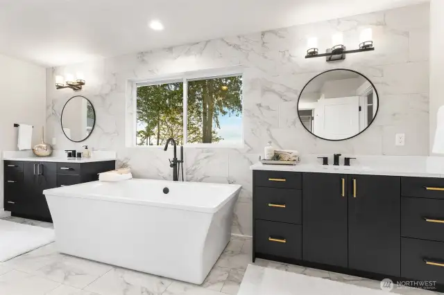 Large vanities separated by soaking tub