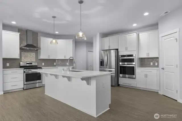 A large peninsula island, quartz counters, and endless storage.