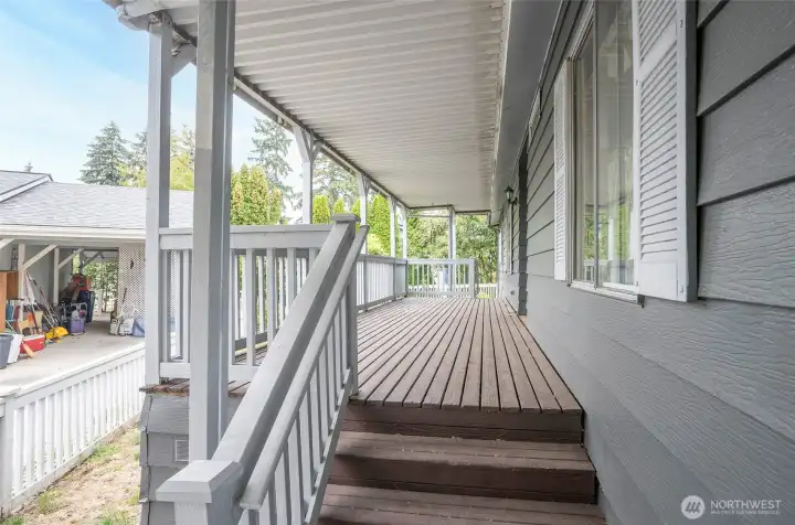 Enjoy a front porch that offers access to the fenced yard at each end.