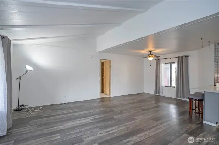 Looking from the living area toward the primary suite door, notice the gorgeous LVP flooring.