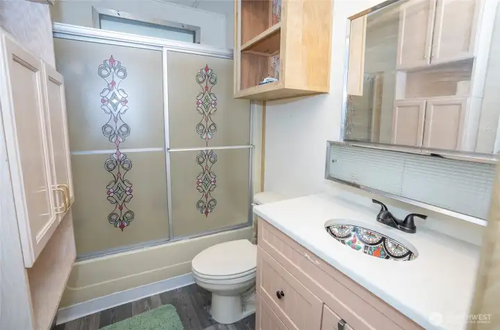 Guest bathroom with a stunning sink and full amenities.
