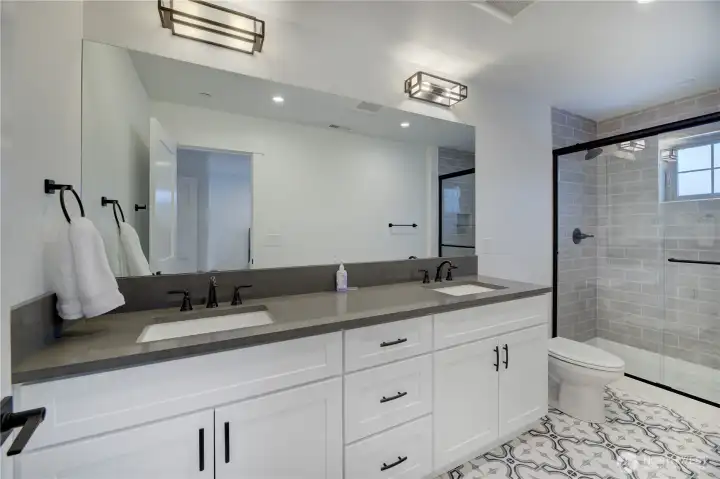 Dual sinkes, tiled floor and fully tiled shower