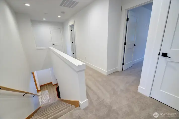 Upstairs is all carpet and white trim in both townhomes