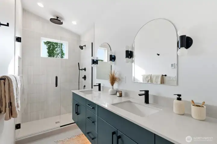 Spa-like primary bathroom with dual sinks, rainfall shower head, and heated floors.