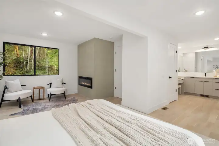 Cozy primary suite with fireplace and seating area