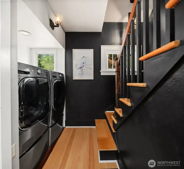 Laundry area with stairs to upper level.