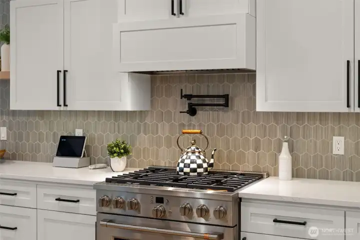 The tiled mosaic backsplash fills the kitchen with warmth.